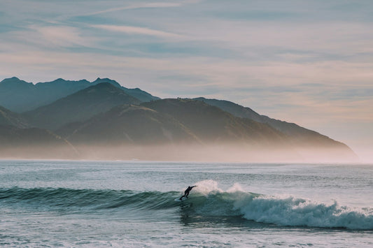 Surfer riding wave in ocean