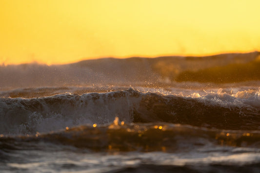 Powerful ocean waves crashing at sunset